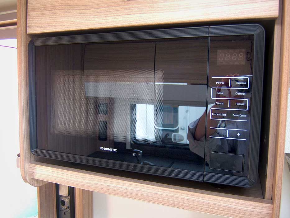 The microwave provides additional cooking and food heating options.